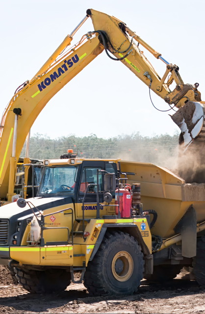 Excavator loading a RoadSide dump truck